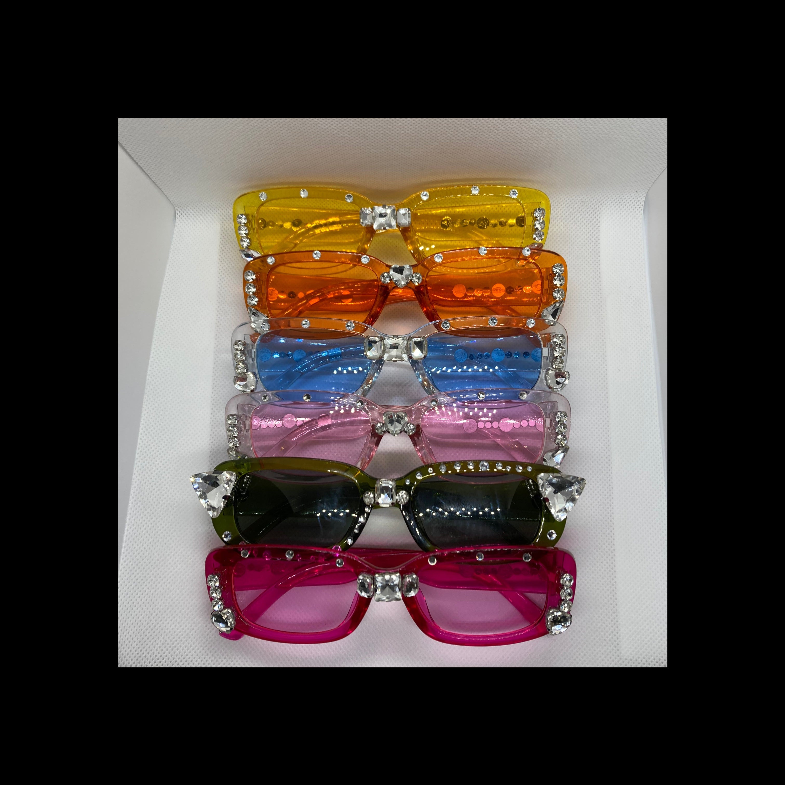 Set of colorful sunglasses with decorative elements on a white background